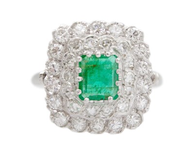 Lot 174 - A platinum, emerald and diamond tiered cluster dress ring