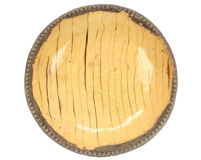 Lot 591 - An English slipware circular dish.