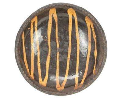 Lot 643 - A small slipware pie or loaf dish.