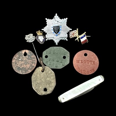 Lot 154 - Four military dog tags, badges, pins and a...