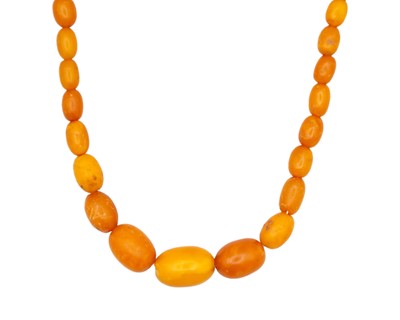 Lot 176 - A graduated butterscotch amber bead necklace.