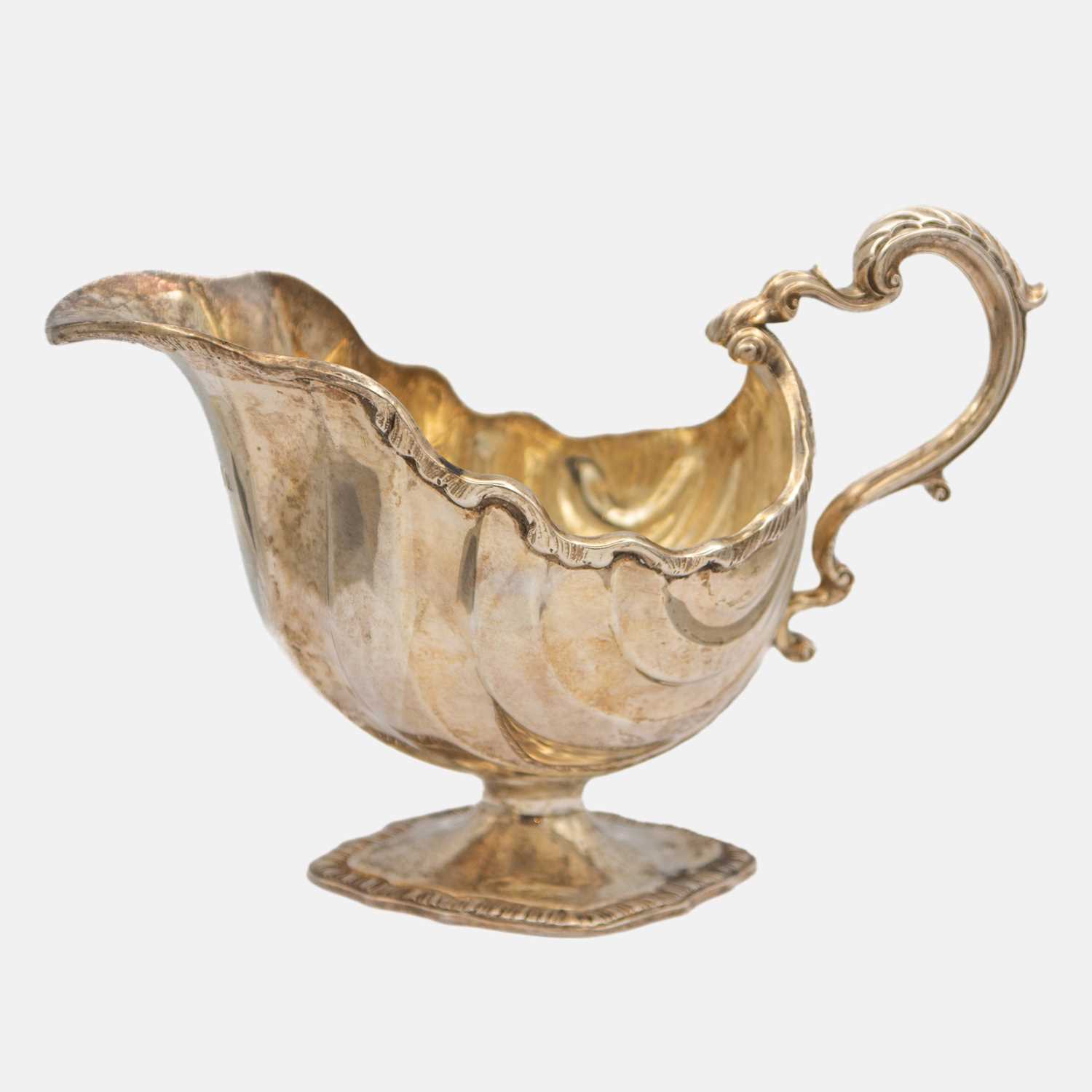 Lot 241 - A good Victorian silver sauce boat of fluted shell pedestal form, by Goldsmiths & Silversmiths Company Ltd.