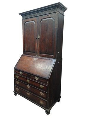 Lot 705 - A George III oak and fruitwood banded bureau bookcase.