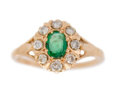 Lot 178 - A rose gold emerald and diamond cluster ring.