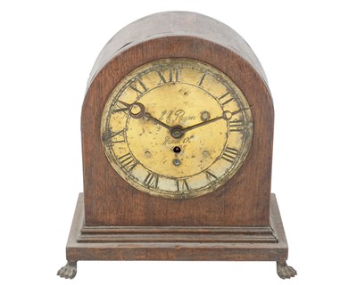 Lot 891 - An oak and brass mantel clock.