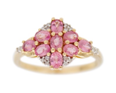 Lot 191 - A 9k gold padparadscha sapphire and diamond cluster ring.