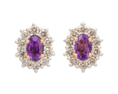 Lot 198 - A pair of 9k yellow gold oval amethyst and diamond cluster studs.