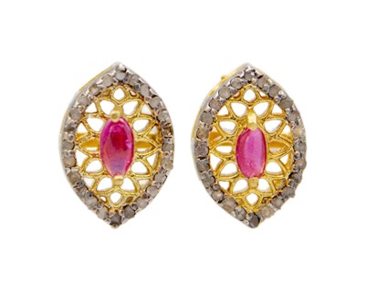 Lot 228 - A pair of silver gilt, ruby, and diamond stud earrings.