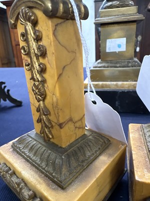 Lot 22 - A pair of orange siena marble candlesticks.