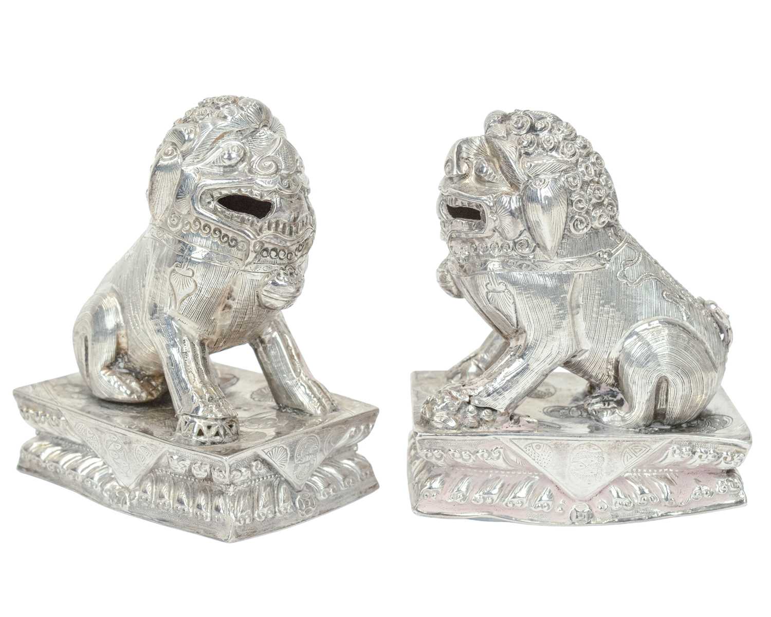 Lot 366 - A pair of Chinese silver foo dogs.