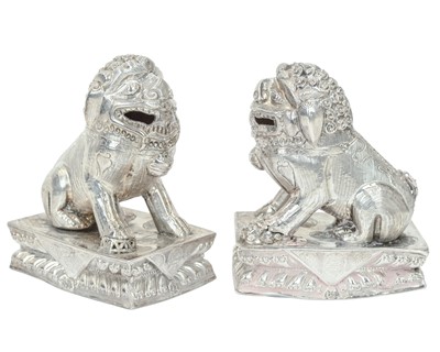Lot 366 - A pair of Chinese silver foo dogs.