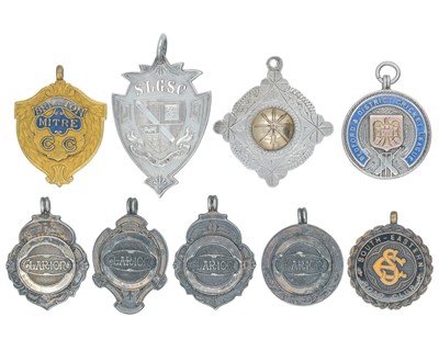 Lot 1115 - A collection of seven silver fobs, and two others.