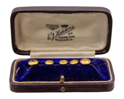 Lot 210 - A set of four 9k gold buttons and one yellow metal paste set button in an original box.