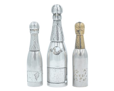 Lot 1103 - Three various propelling pencil fobs in the form of champagne bottles, two in silver (tested).