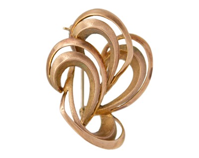 Lot 221 - A 9k gold abstract design brooch.