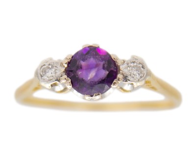 Lot 238 - An 18k gold three-stone amethyst and diamond ring.