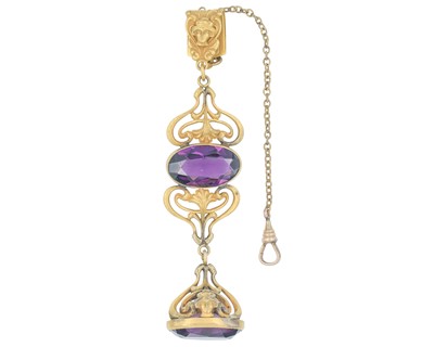 Lot 1088 - An Art Nouveau gold-plated fob pendant with purple paste stone and seal.