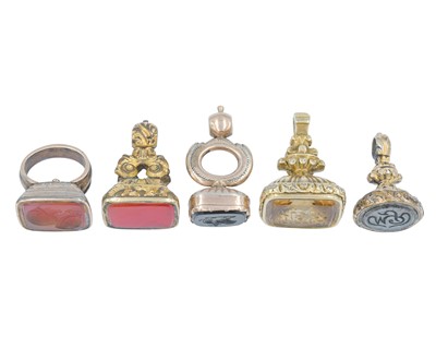 Lot 1113 - A collection of five 19th-century gold-plated watch fob seals.