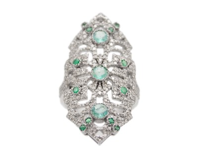 Lot 236 - An Art Deco style white metal diamond and emerald set elongated panel ring.