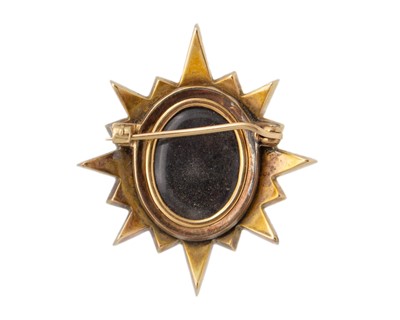 Lot 39 - A Victorian high-purity gold, enamel, and pearl set mourning star brooch.