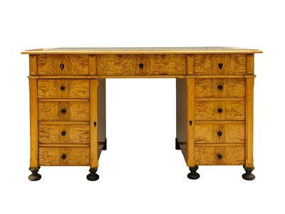 Lot 962 - A Biedermeier style satin birch twin pedestal desk.