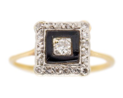 Lot 237 - An Art Deco 18k gold diamond and black enamel ring.