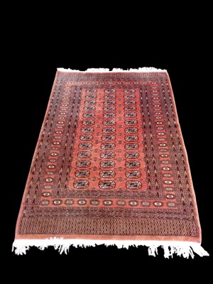 Lot 175 - A machine-made wool Orange ground rug. 130 x...