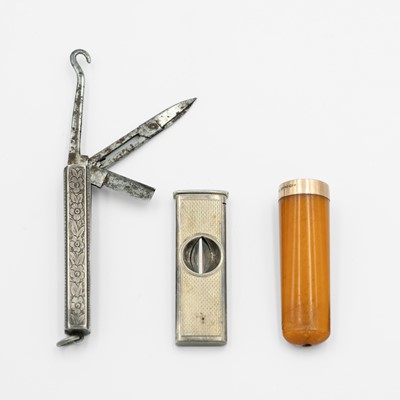Lot 212 - A Victorian silver combination pocket knife fob, an amber 9k mounted cheroot holder & a silver cigar cutter.