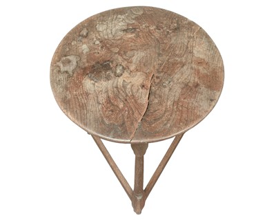 Lot 666 - An elm and oak circular cricket table.