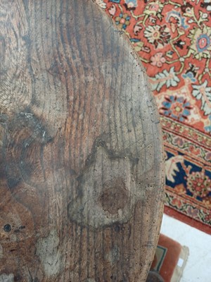 Lot 666 - An elm and oak circular cricket table.