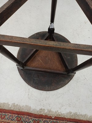 Lot 666 - An elm and oak circular cricket table.