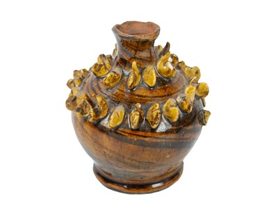 Lot 614 - A treacle glazed agateware money box.