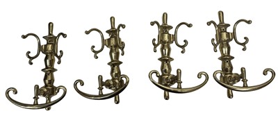 Lot 44 - A set of four Victorian brass double coat/hat...