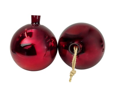 Lot 714 - A pair of red glass witch balls.