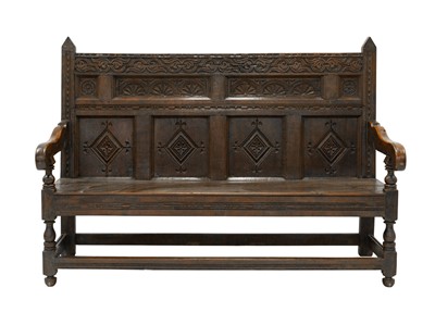 Lot 774 - An oak panel back settle.