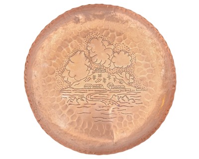 Lot 200 - A Newlyn copper tray of circular form, decorated to the centre with St. Michael's Mount.