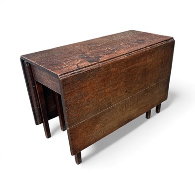 Lot 34 - An Antique Georgian oak drop-leaf dining table,...