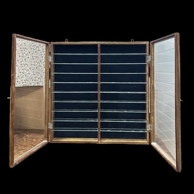 Lot 163 - A glazed double door display case with glass...