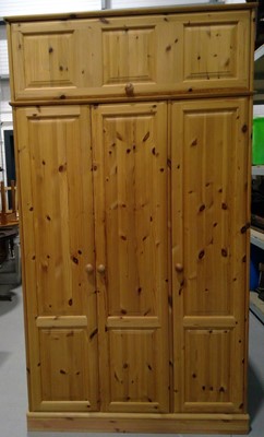 Lot 21 - A Pine Wardrobe with Overhead Storage. The...