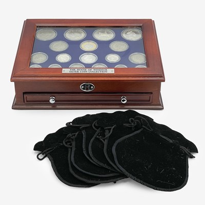 Lot 176 - The House of Windsor Silver Coin Collection by Danbury Mint, in deluxe wooden collector's cabinet.