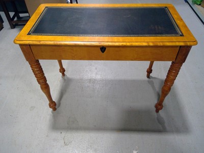 Lot 42 - An Elm Writing Desk. The Desk is 76cm tall,...