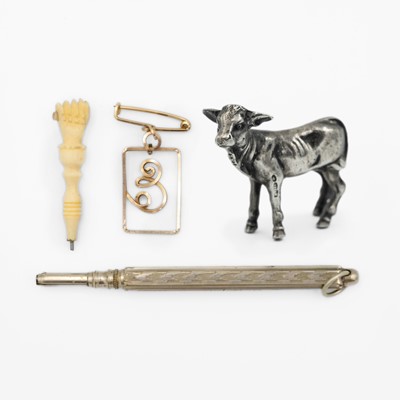 Lot 242 - A 925 silver miniature model of a calf, a bone Stanhope finial, propelling pencil and gold-plated brooch.