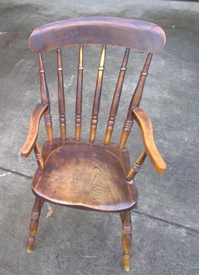 Lot 29 - An Antique Elm Spindle Back Armchair.