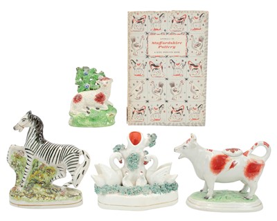 Lot 278 - Four Staffordshire pottery animal figures.
