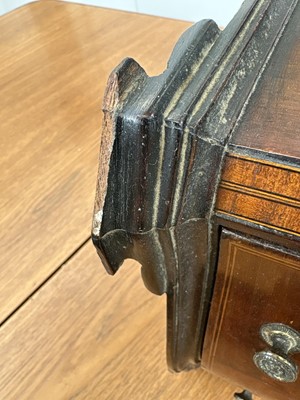 Lot 95 - A 19th century mahogany, inlaid and crossbanded serpentine front miniature chest.