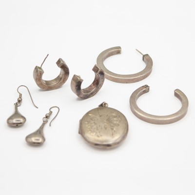 Lot 55 - A selection of three silver earrings and a silver locket pendant.