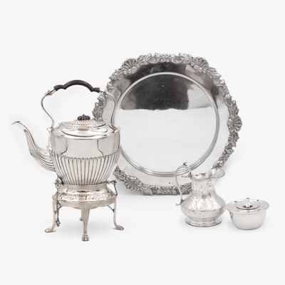 Lot 245 - A selection of three silver-plated wares to include a spirit kettle, a salver and a cream jug.