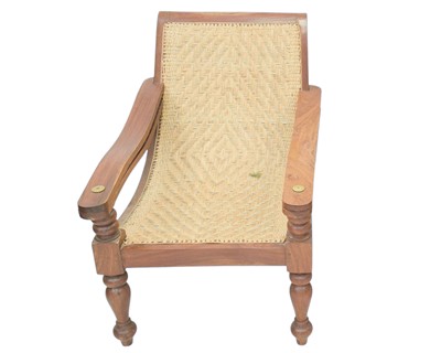 Lot 879 - A teak and rattan plantation chair.