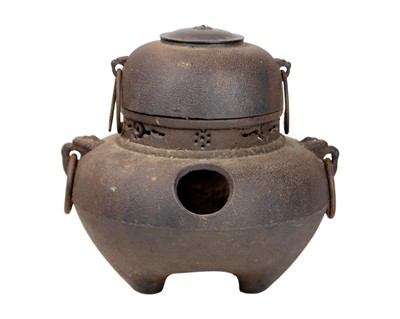 Lot 393 - A Japanese cast iron and copper chagama tea kettle.