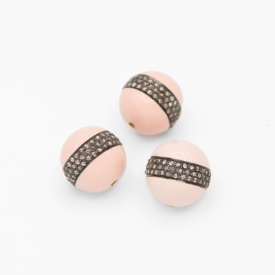 Lot 62 - A set of three silver powder pink enamel beads each with a band of diamonds.